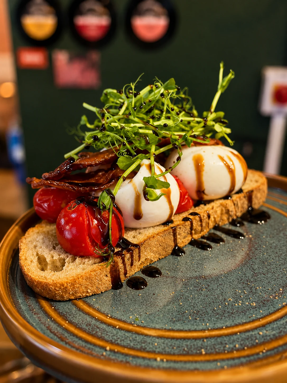 Toast topped with burrata, tomatoes and greens at Outset Coffee
